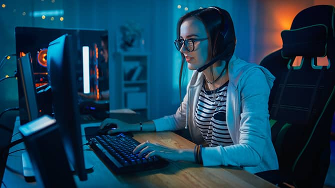 A woman playing online games. Gaming is fun, but it's important to be aware of online gaming security.